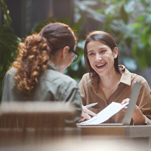 Two young people depicted as happily discussing an article